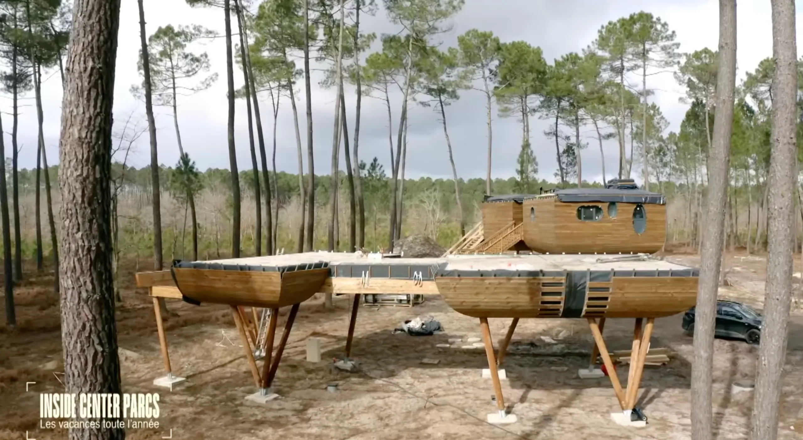 Vue sur les cabanes dans les arbres en cour de construction où apparaissent les pieds en bois lamellé-collé tournés par Woodspars. Ces logements athypiques du Domaine Les Landes de Gascogne de Center Parcs et sont visibles dans l'émission Inside Center Parcs sur la chaine BFM Story
